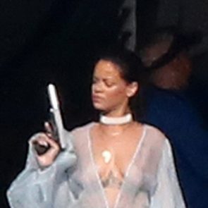 rihanna playing with gun on set